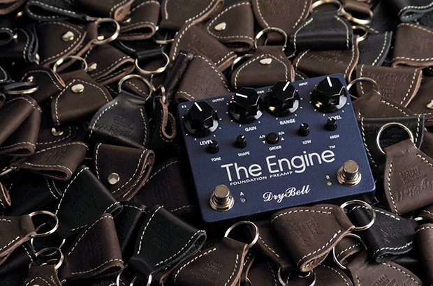 he Engine guitar pedal surrounded by a multitude of DryBell keychain pick holders.