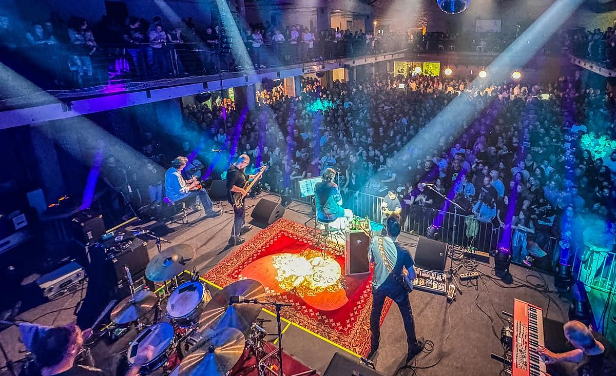 Kruno Domacinovic, a member of the DryBell team, performing on stage with his band 'Majke,' an iconic Croatian rock band.