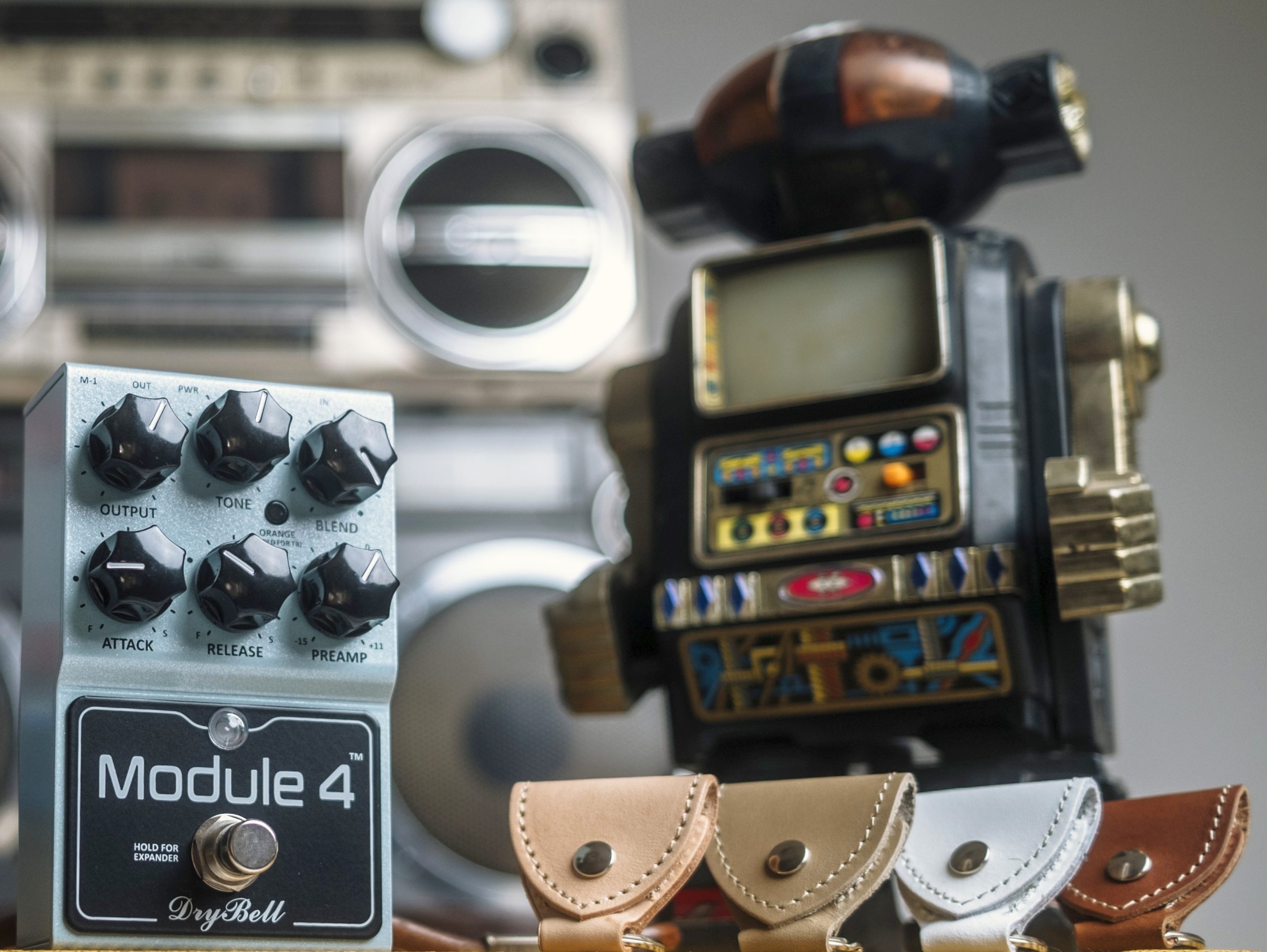 DryBell leather keychain pick holder gift alongside Module 4 pedal and several '80s cassette players.