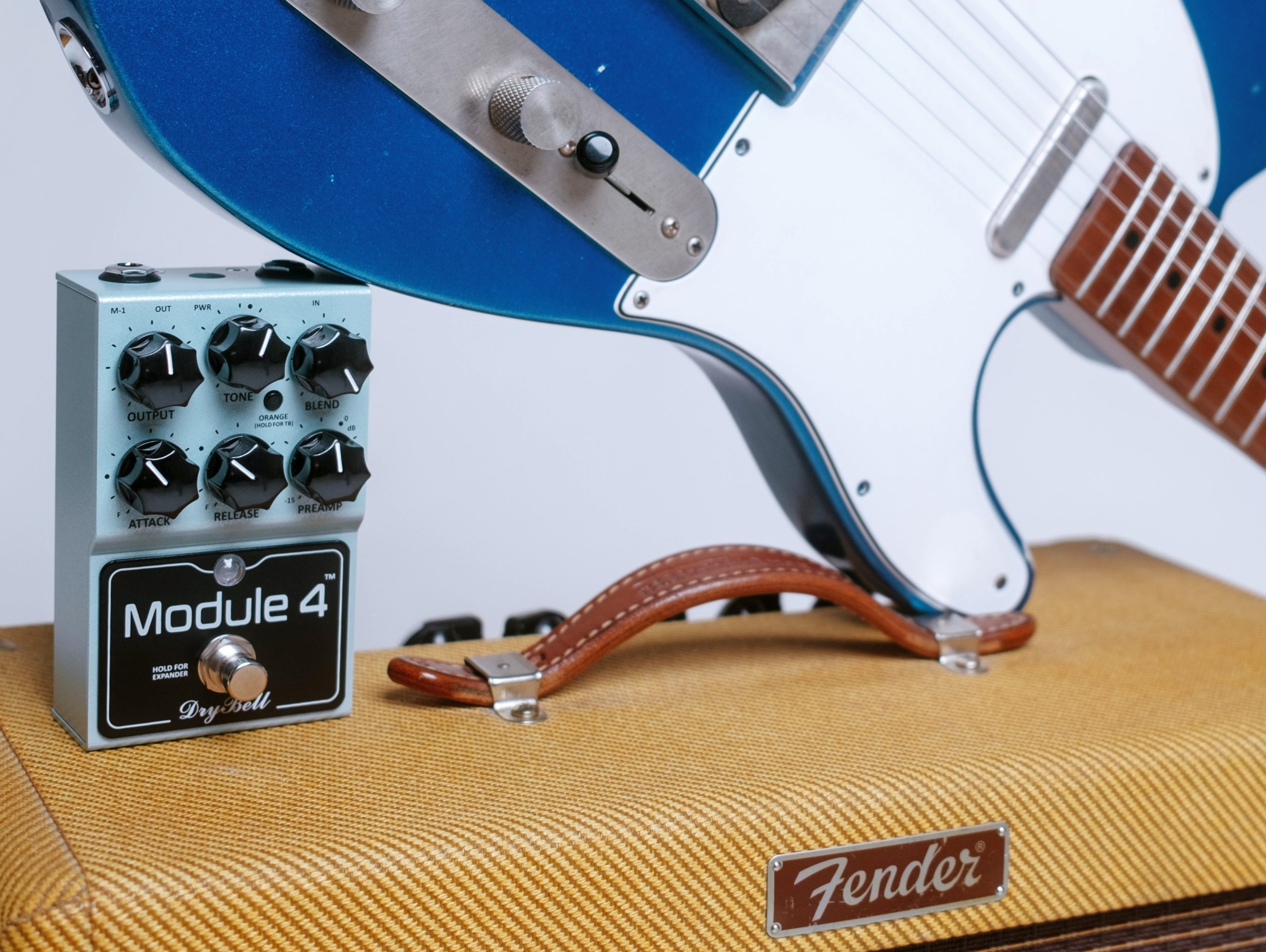 DryBell Module 4 pedal placed on a tweed amp, alongside a Telecaster guitar.