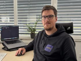 Mario Vuzem, DryBell's production test software developer, sitting at his desk with a PC displaying software code on the screen.