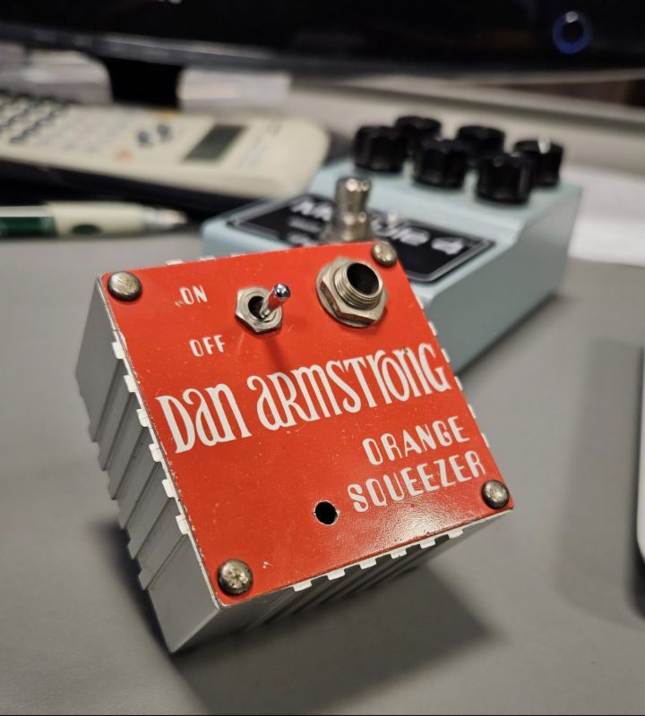 Dan Armstrong's Vintage Orange Squeezer pedal in the front, with DryBell Module 4 compressor pedal in the background.
