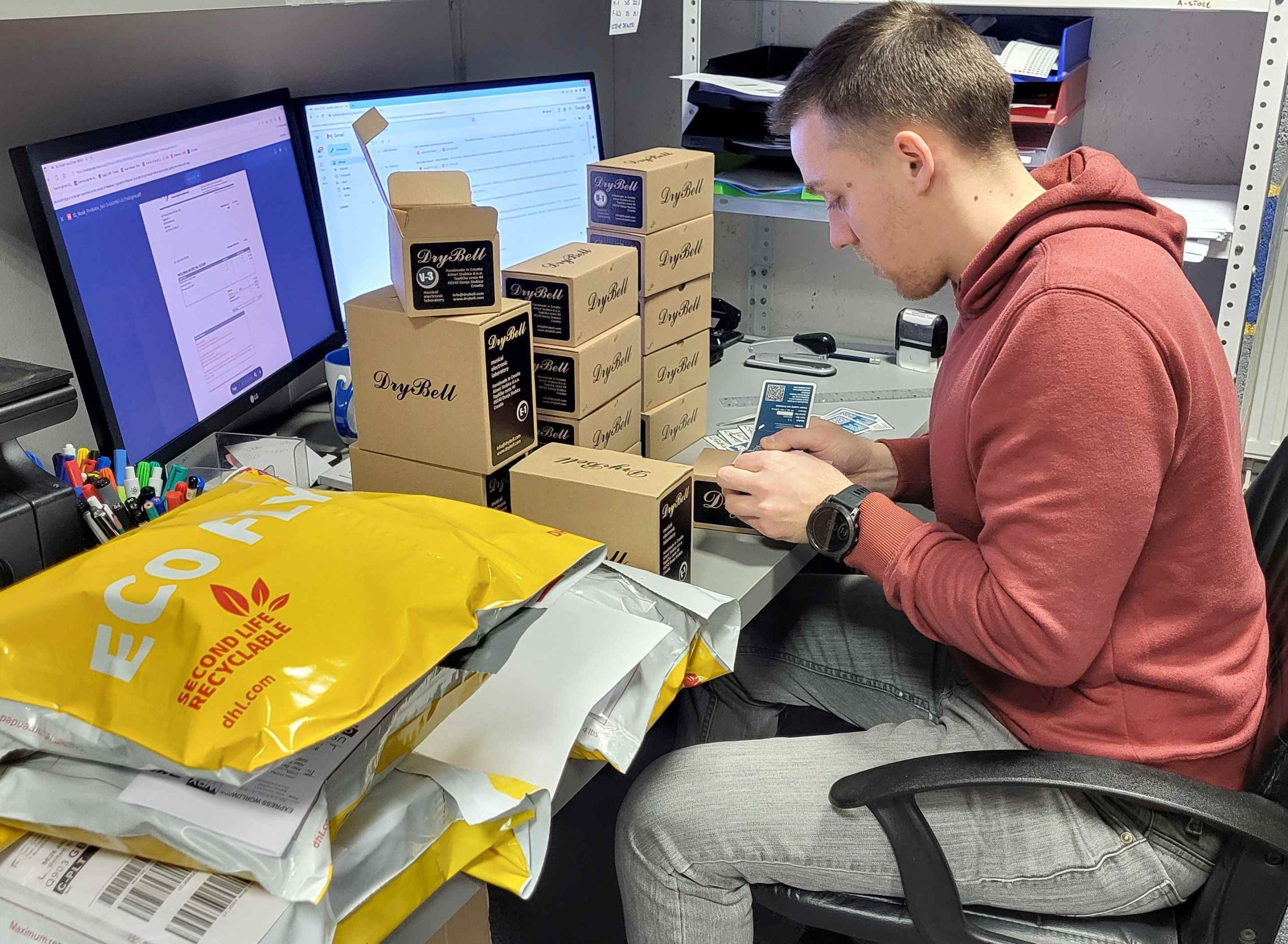 Guitar pedals being packed for DHL shipping at DryBell office.